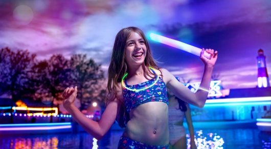 child smiling and enjoying the wave pool